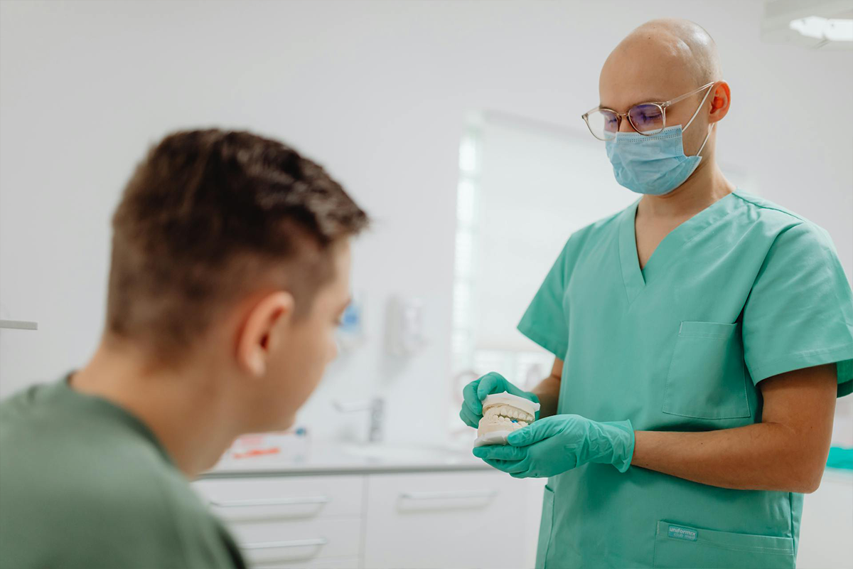 Dentist Showing Patient Teeth
